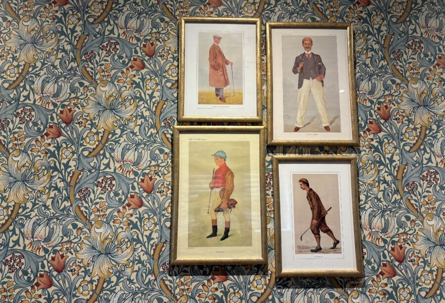 A picture of four gold-framed pictures against a flower-patterned wallpaper at Manor House Lindley.