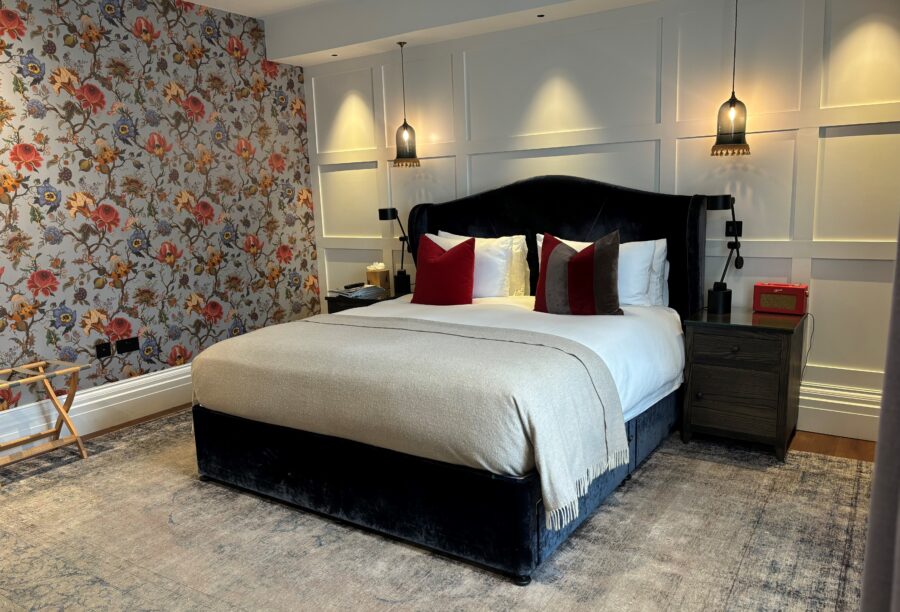 A picture of a king bed at the Manor House Lindley Hotel