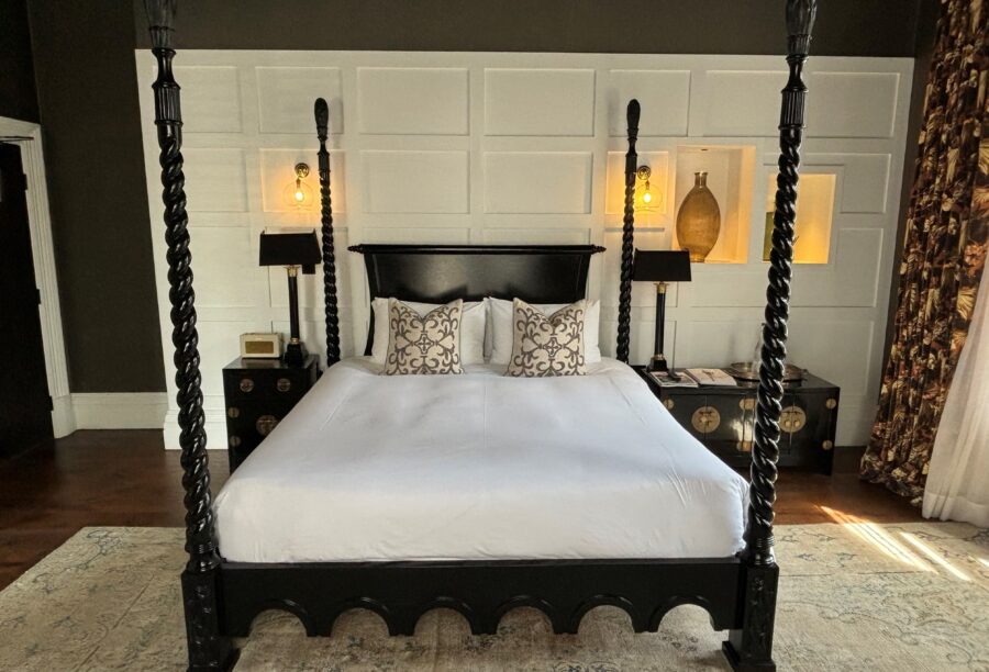 Four-poster bed with wooden paneling at Manor House Lindley.