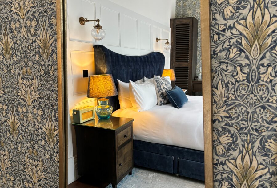 A picture of a bedroom reflected in a mirror at Manor House Lindley.