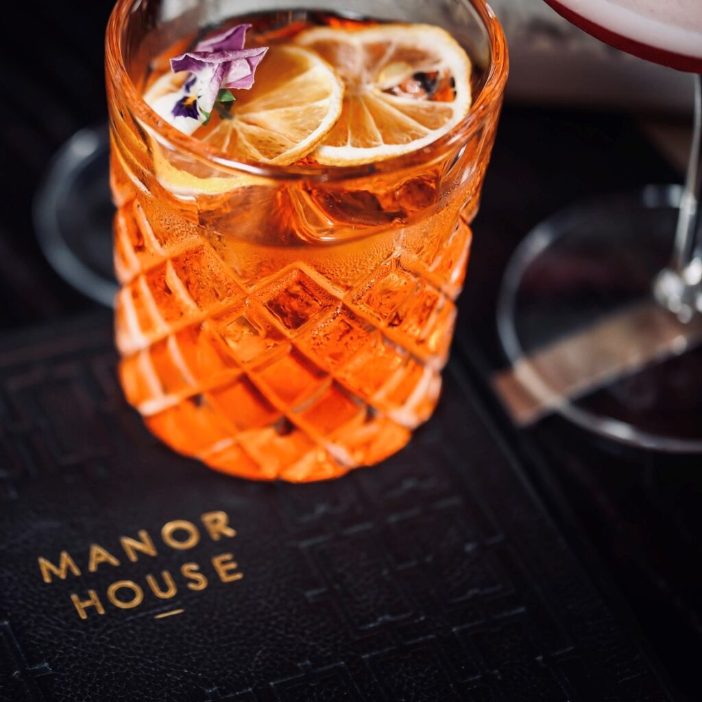 A close-up picture of a cocktail at the bar of Manor House Lindley