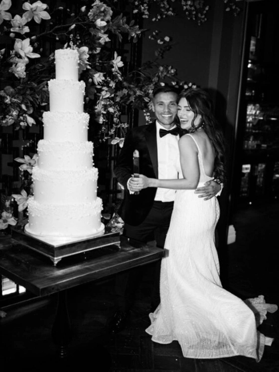 Bride Erika and Groom Edie cutting a wedding cake