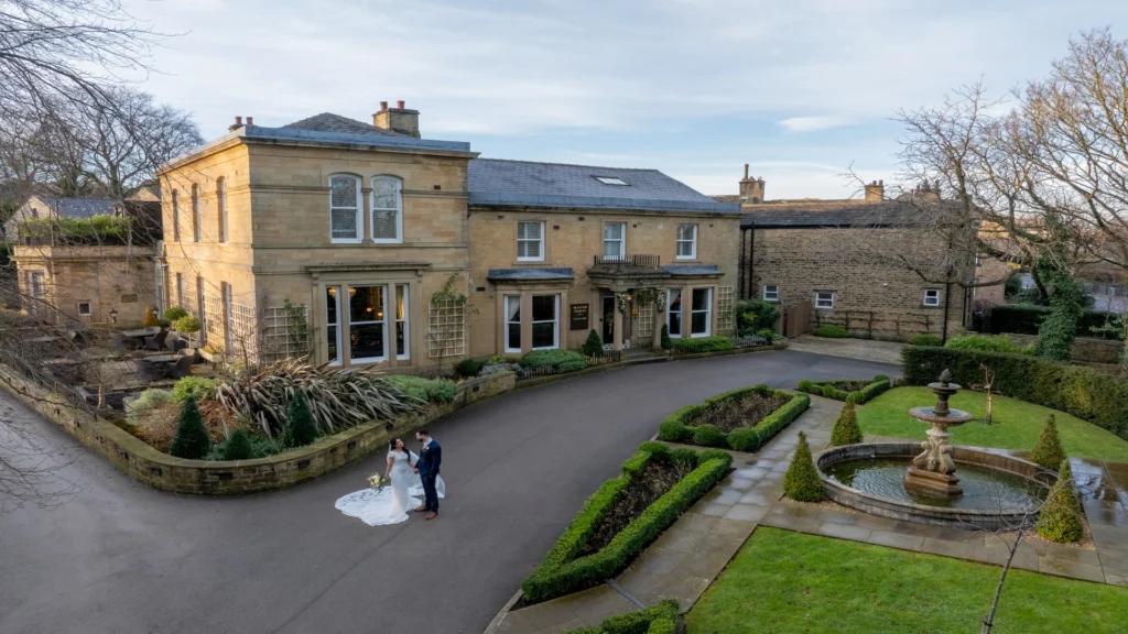 An aerial view of bride and groom outside the Manor House Lindley