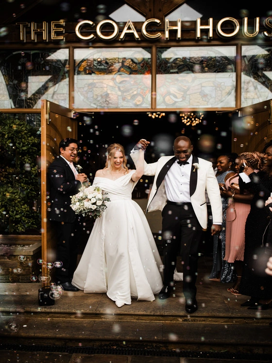 Bride and Groom leaving the wedding venue at Manor House Lindley celebrating after getting married