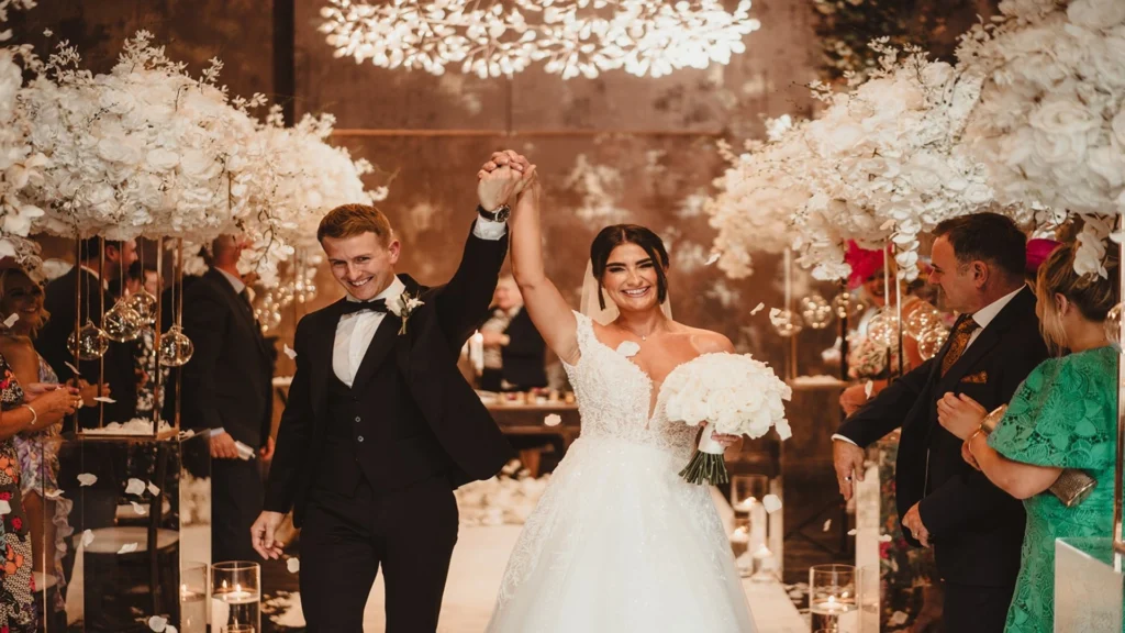 Bride and groom walking down the aisle, celebrating after getting married