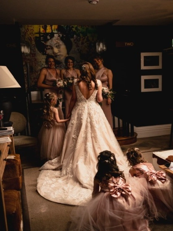 A picture of Katie, Bride and Bridesmaid, at the entrance of Room 1 in Manor House Lindley