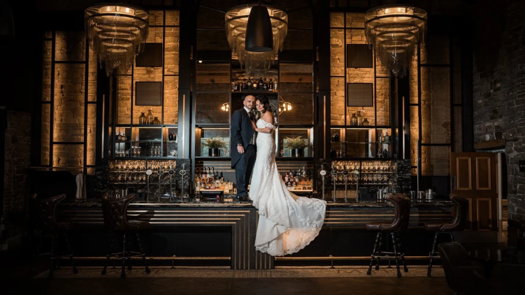 Bride and Groom having a picture on the bar inside Manor House Lindley