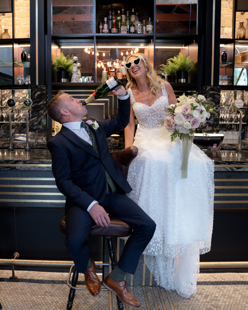 Groom Aaron and Bride Sam having picture at the bar at Manor House Lindley