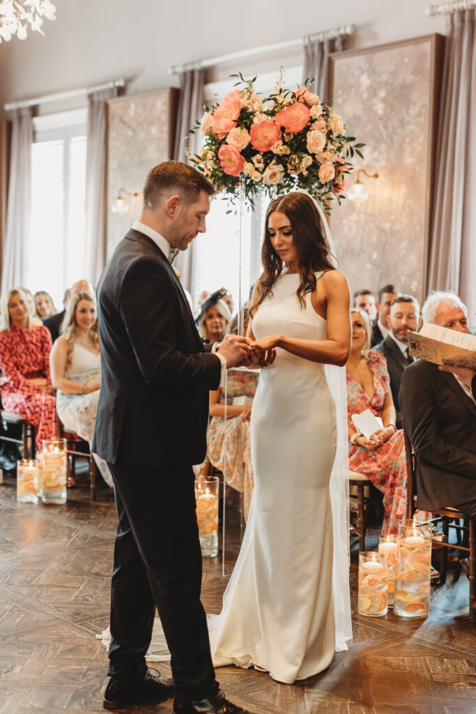 Tom Groom putting wedding ring on Bride Alanna at the wedding venue at Manor House Lindley