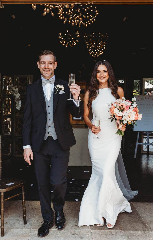 Bride Alanna & Tom Groom having a glass of fizz at the wedding venue at Manor House