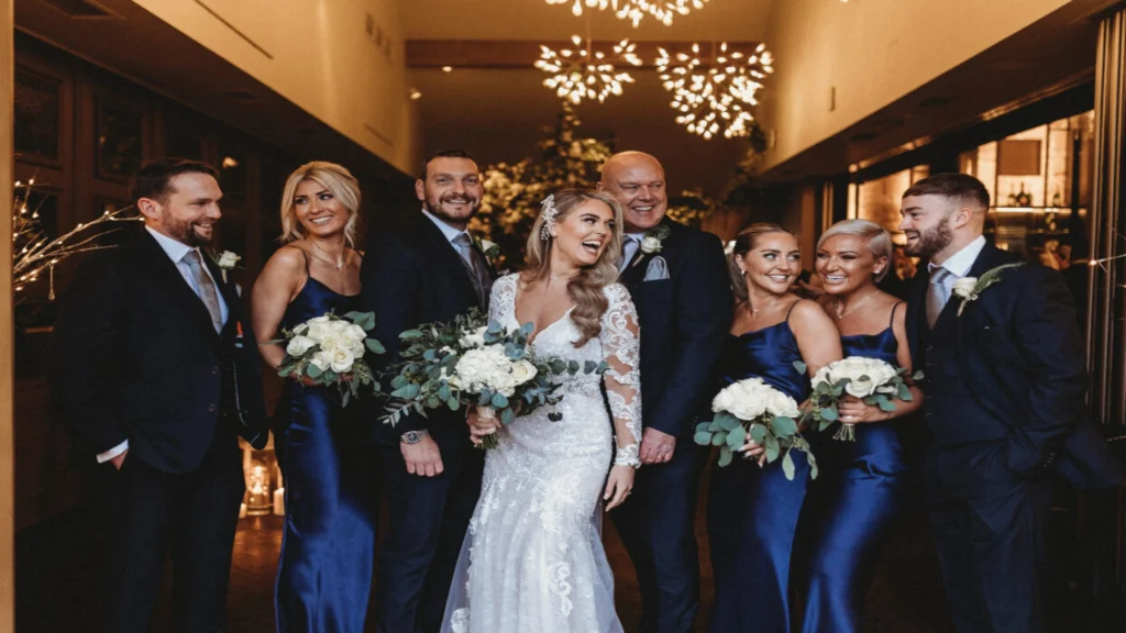 Bride and Groom surrounded by bridesmaids, bestman, family and friends