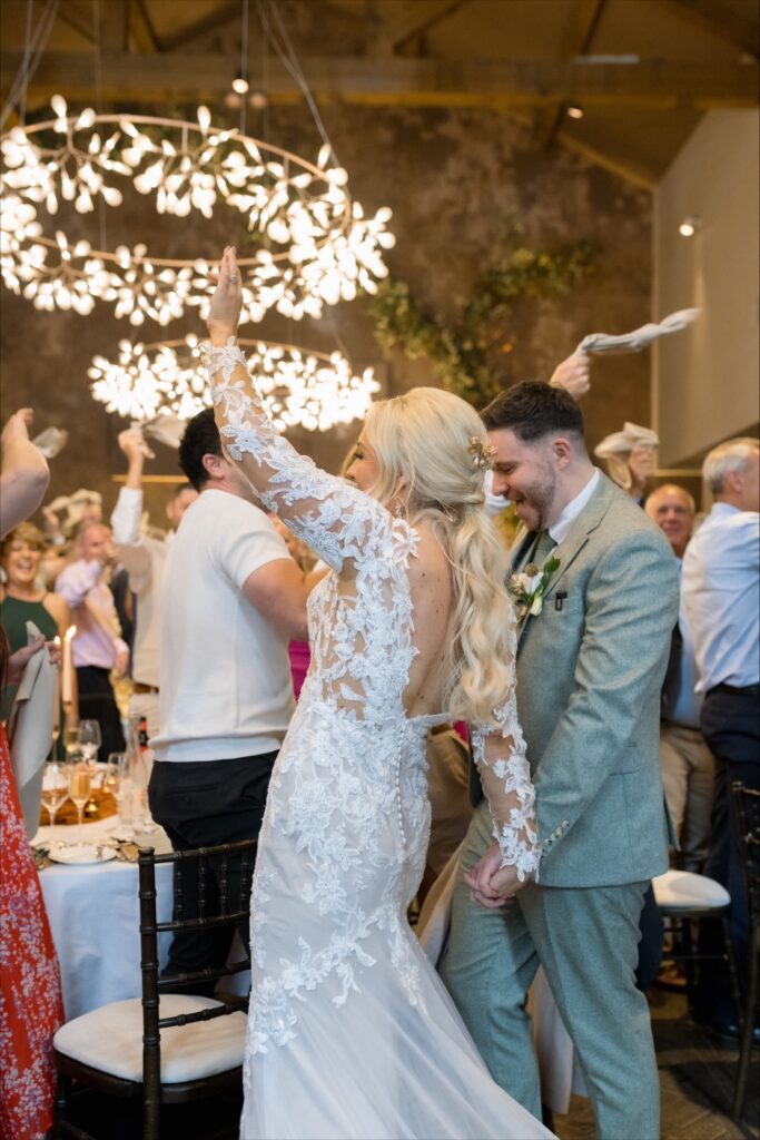 Bride and groom celebrating inside the wedding venue with family and friends at Manor House Lindley