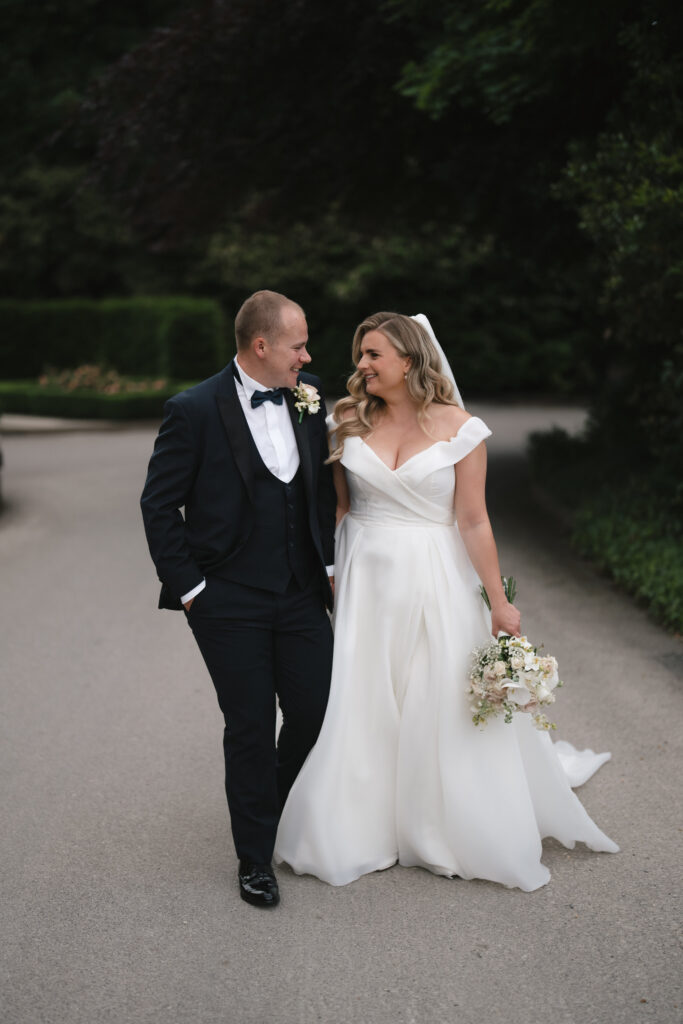 Bride, Libby and groom, John walking around the grounds at Manor House