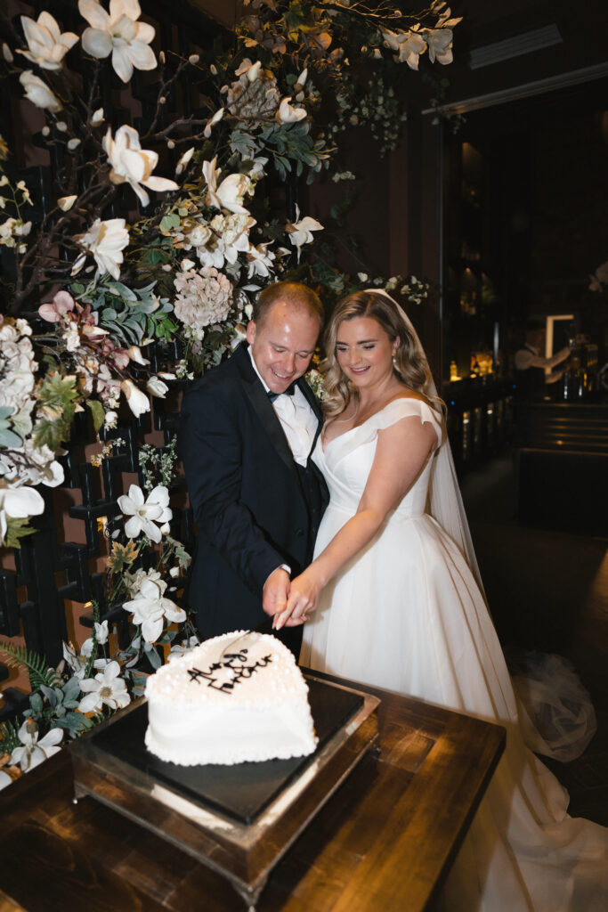 Bride, Libby and groom, John cutting the wedding cake